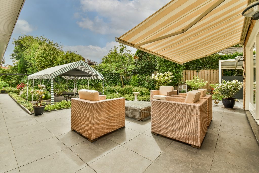 attached semi-covered patio in backyard of home 

